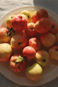 A white plate with apples on it